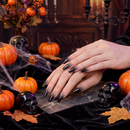 Woman wearing glossy gray and white Gemini II press-on nails with a Halloween-inspired look.