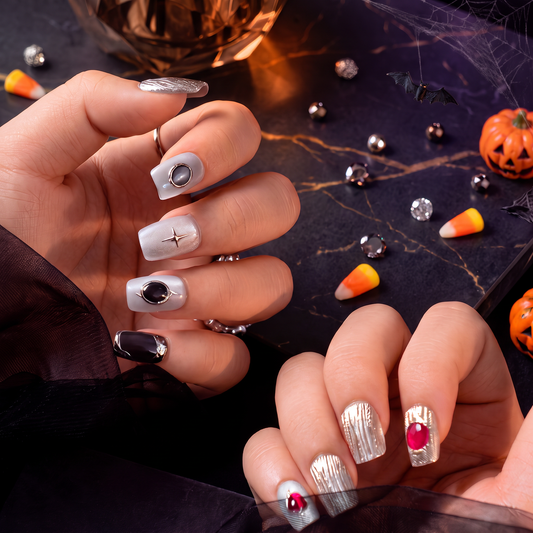 Woman wearing dark Scorpio Zodiac press-on nails with a spooky Halloween-inspired look.