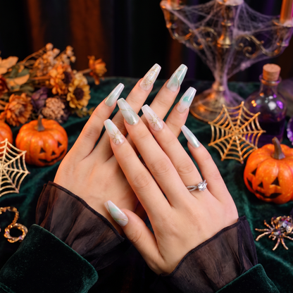 Woman wearing unique Aquarius Zodiac press-on nails with a Halloween-inspired look.