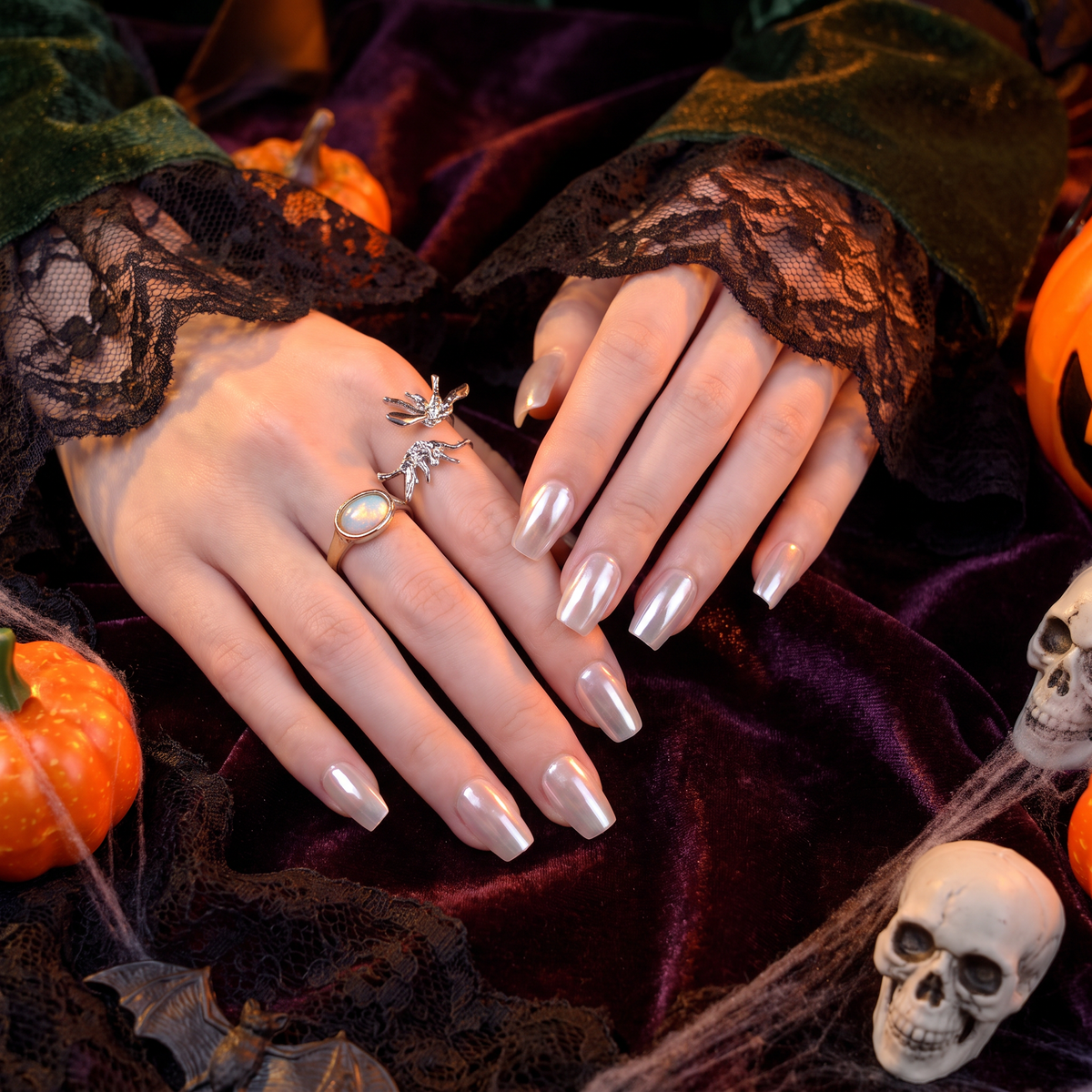Woman wearing elegant Aurora White press-on nails with a Halloween-inspired outfit.