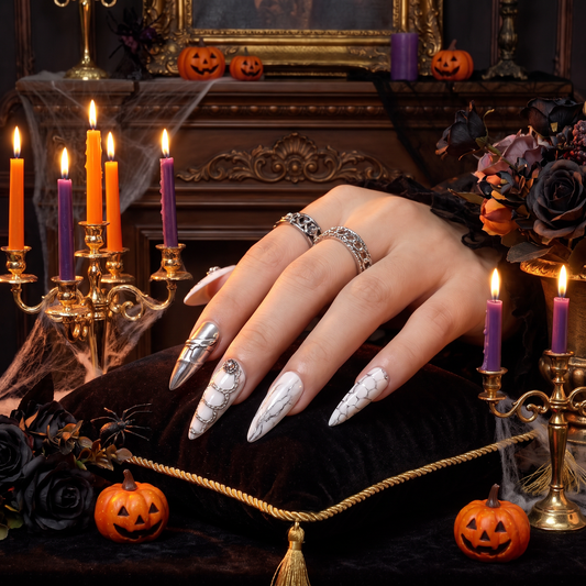 Woman wearing Cancer Zodiac press-on nails with a soft Halloween-inspired beauty look.